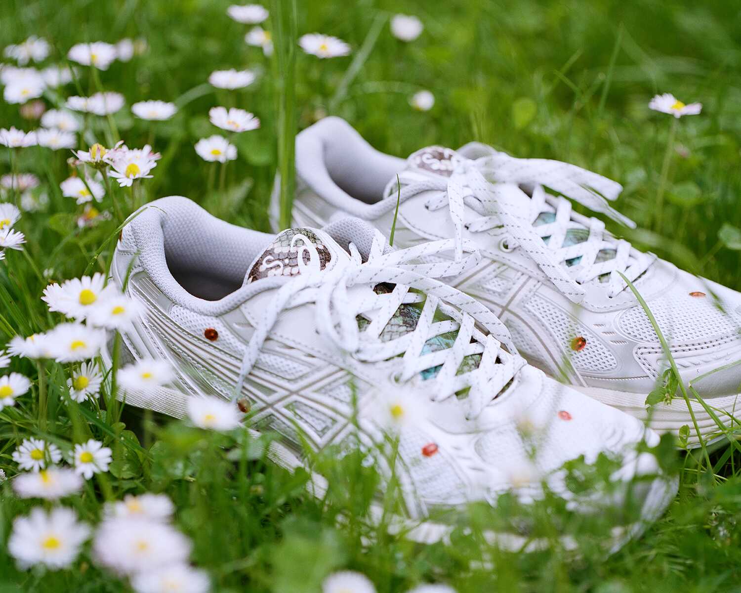 S.A x Asics limited edition shoe featuring a silver upper with ladybug prints and imitation snake leather tongue.