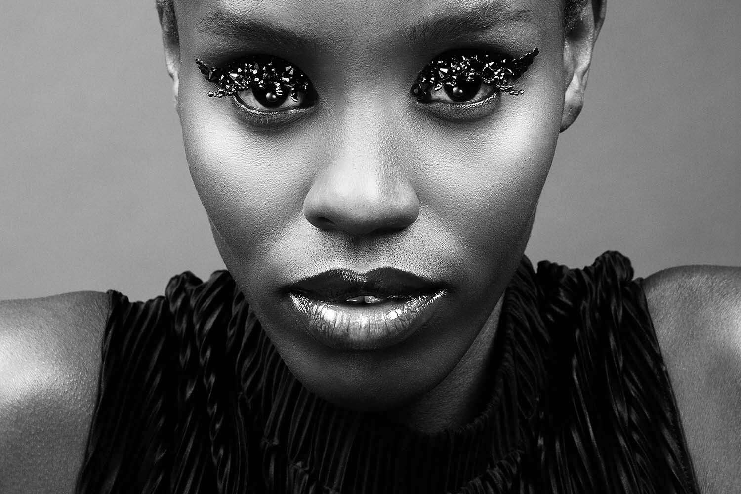 Crystallized editorial: bold front view with graphic eyeliner and crystals layered along the lid