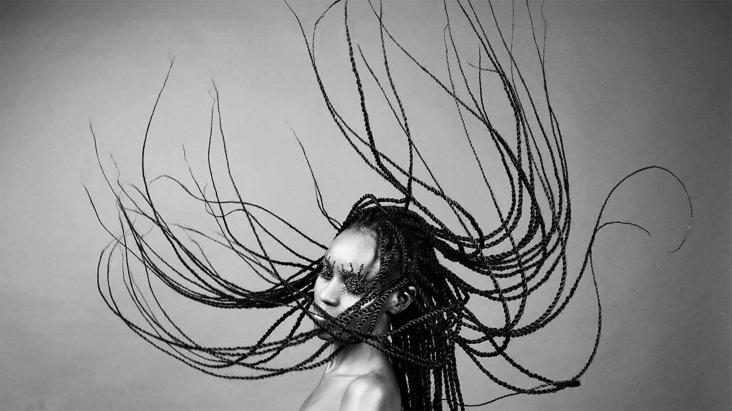 Crystallized editorial: flying braids and exaggerated crystal lashes