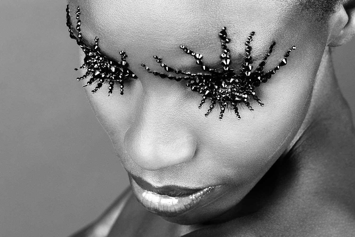 Crystallized editorial: close crop with surreal lashes reaching past eyebrows
