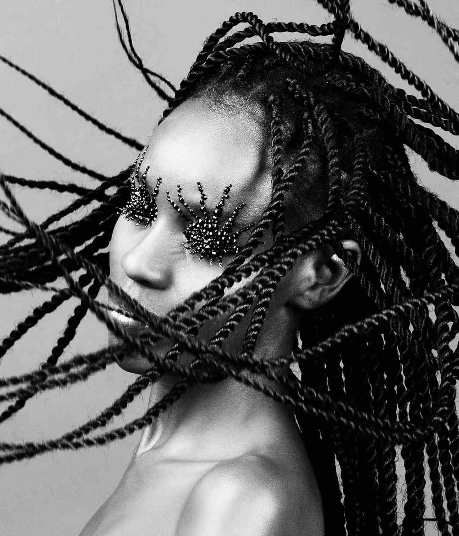 Crystallized editorial: obscured face with braids in motion and final maximal styling