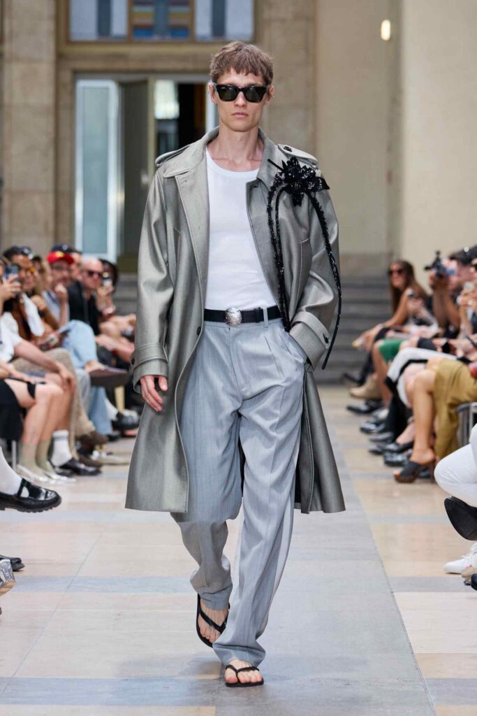 Metallic coat with black hibiscus brooch at David Koma SS26 BFW