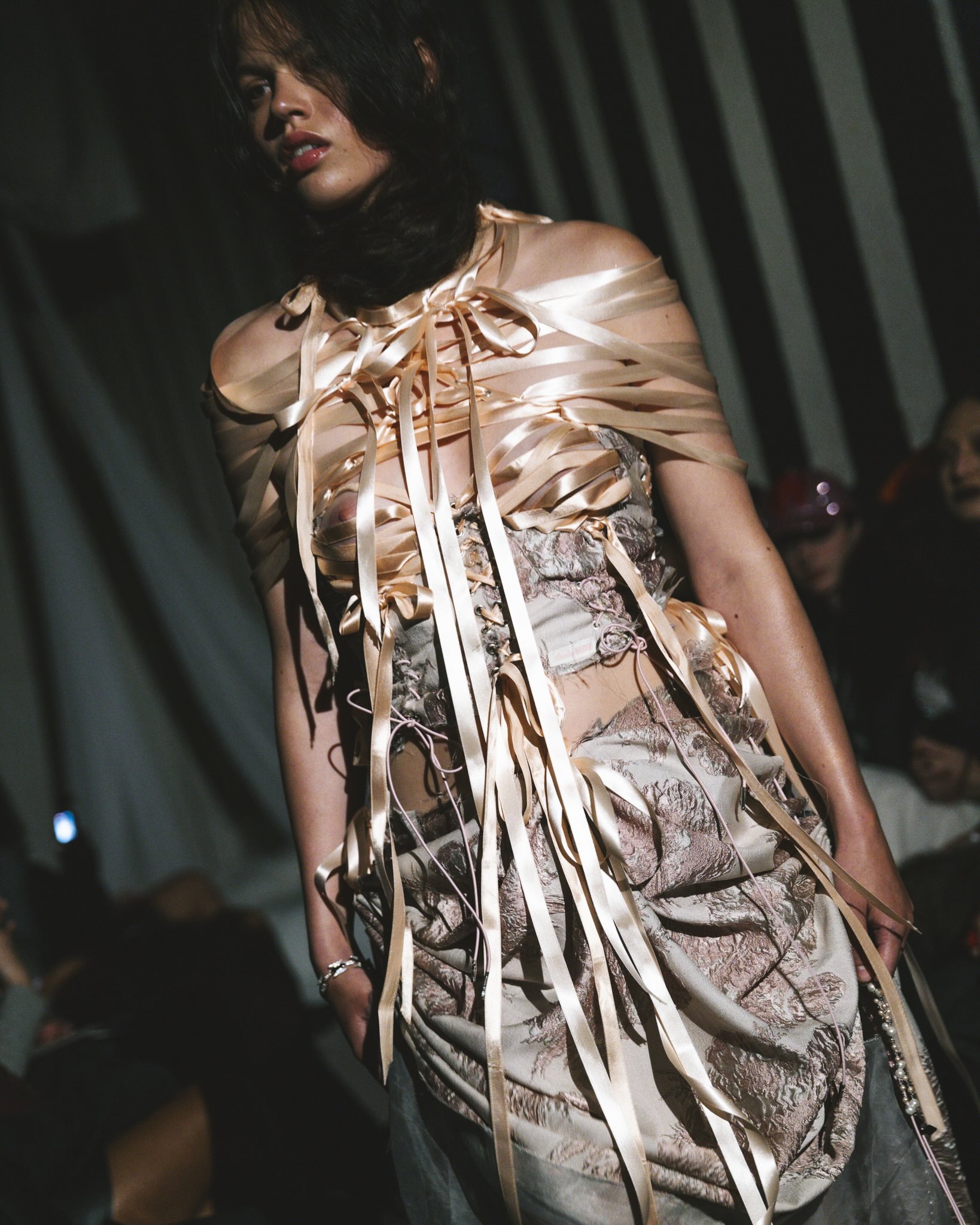 Runway photograph of Pauline Blind’s Blasphemous Bodies collection at Amsterdam Fashion Week, featuring models in veils, layered garments, and symbolic accessories.