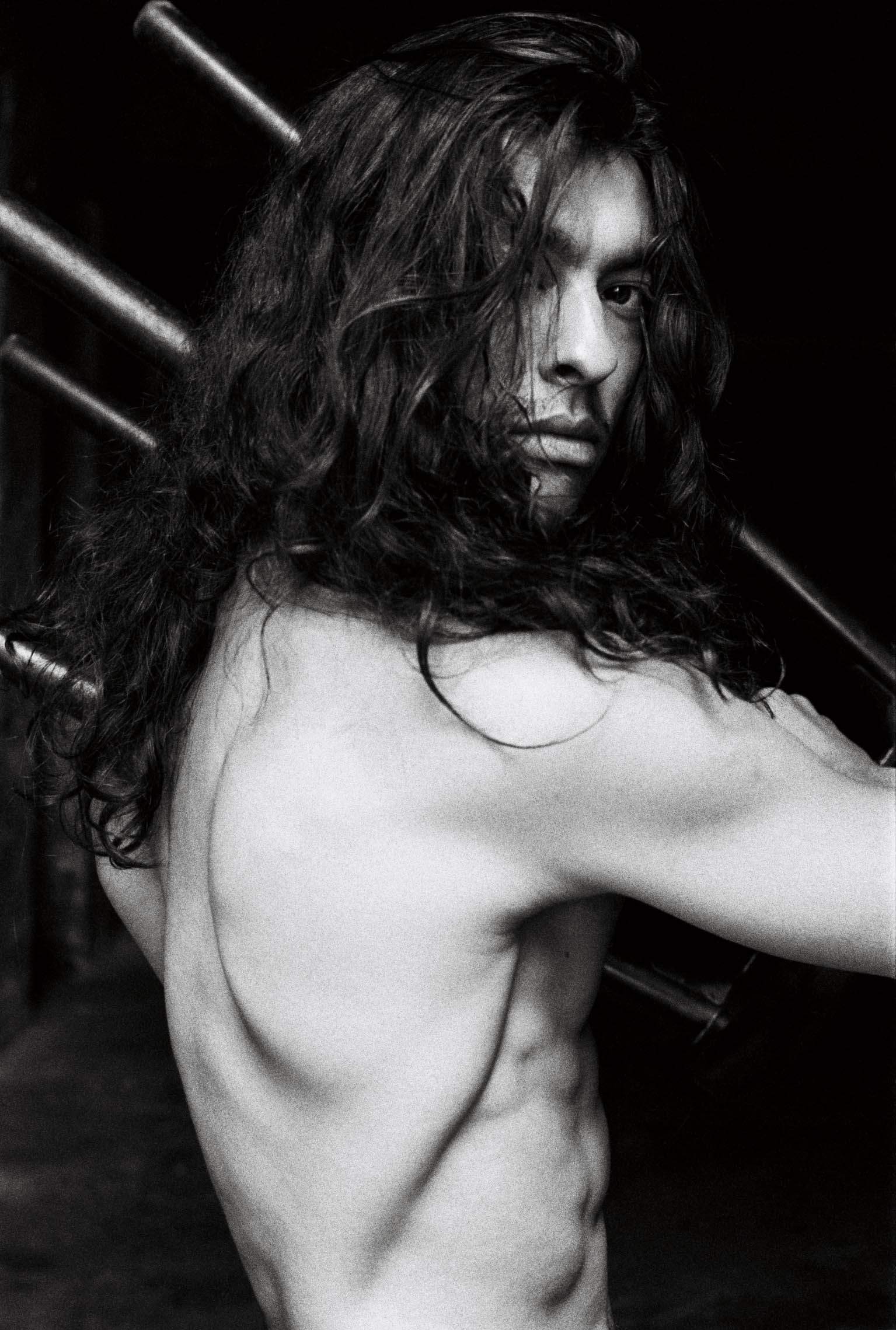 portrait taken by Sven Marquardt, showing a man with long hair 